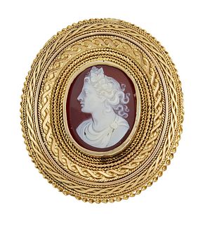 A HARDSTONE CAMEO BROOCH
 The oval plaque, carved 