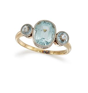 AN AQUAMARINE THREE-STONE RING
 The central collet