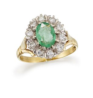 AN EMERALD AND DIAMOND CLUSTER RING
 The oval-cut 