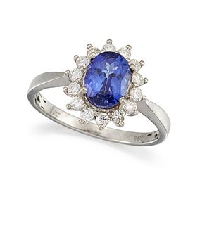 A TANZANITE AND DIAMOND CLUSTER RING
 The oval-cut