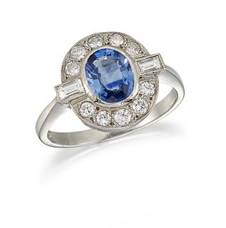 A SAPPHIRE AND DIAMOND RING
 The collet-set oval-c