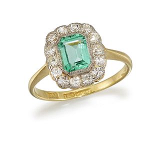 AN EMERALD AND DIAMOND CLUSTER RING
 The octagonal