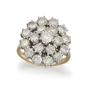 A DIAMOND CLUSTER RING
 Designed as a tiered radia