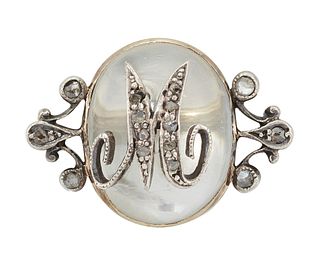 A MOONSTONE AND DIAMOND BROOCH 
 The oval cabochon