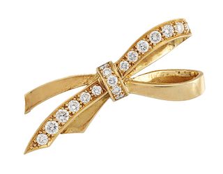 A DIAMOND-SET BOW BROOCH
 The polished bow accente