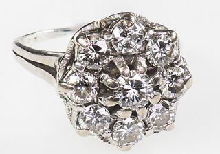 A DIAMOND CLUSTER RING, 1975
 The tiered cluster o