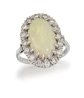 AN OPAL AND DIAMOND CLUSTER RING
 The oval cabocho