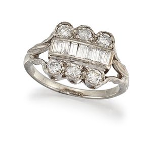 A DIAMOND DRESS RING
 Centred by a channel-set row