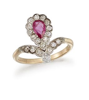 A RUBY AND DIAMOND DRESS RING
 The pear-shaped rub