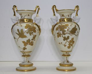 Pair of Gilt Decorated Porcelain Urns.