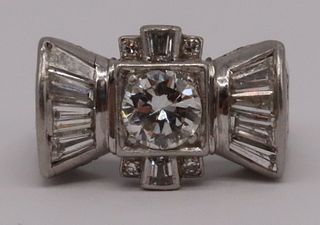 JEWELRY. Platinum and Diamond Bow Form Ring.