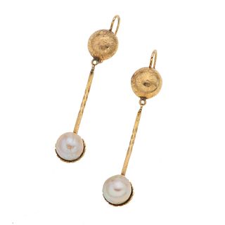 Par de aretes con perlas en oro amarillo de 14k. 2 perlas cultivadas color crema de 8 mm. Peso: 6.3 g.