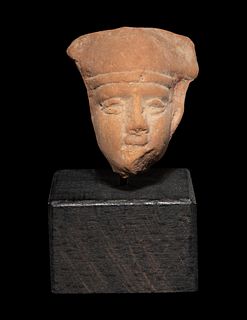 An Egyptian Terra Cotta Head of Horus