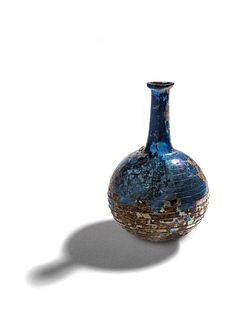 A Roman Blue Glass Bottle with Spiral Trail