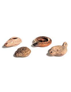 Four Roman Molded Terra Cotta Oil Lamps
Width of widest 5 3/8 inches.