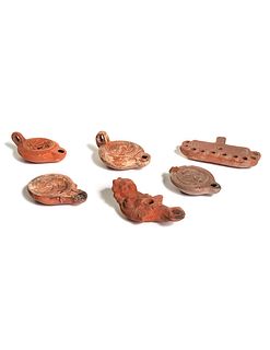 Six Roman Molded Terra Cotta Oil Lamps
Width of widest 5 1/2 inches.