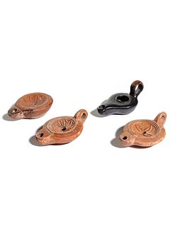 Four Roman Molded Terra Cotta Oil Lamps
Width of first 3 3/4 inches.