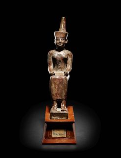 An Egyptian Gold Inlaid Bronze Seated Neith
Height 7 7/8 inches.
