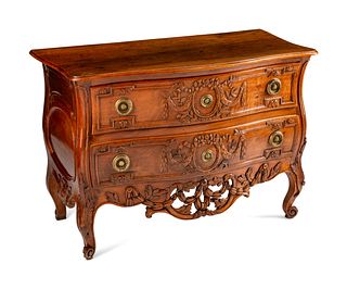 A Louis XV Provincial Carved Walnut Commode
Height 35 1/2 x length 51 x depth 26 inches.