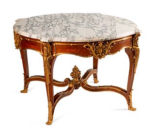 A Louis XV Style Gilt-Bronze-Mounted Kingwood Table de Milieu
Height 33 x diameter 53 1/2 inches.