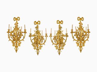 A Set of Four Louis XV Style Gilt-Bronze Five-Light Sconces
Height 37 x width 19 x depth 13 1/2 inches.