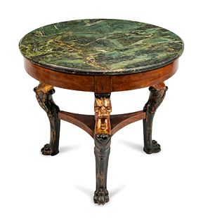 An Empire Style Parcel-Gilt Mahogany Table
Height 29 1/2 x diameter 33 1/2 inches.