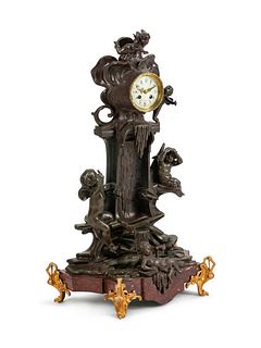 A French Patinated Bronze and Marble Mantel Clock
Height 31 x width 20 x depth 11 1/2 inches.