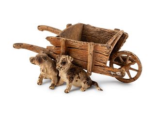 An Austrian Cold-Painted Group of Dogs and a Wheelbarrow
Height 1 1/2 x length 4 x depth 2 1/2 inches.