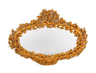 An Italian Rococo Style Carved Giltwood Oval Mirror
Height 51 1/2 x length 69 x depth 2 inches.