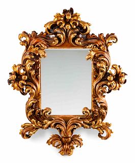 An Italian Rococo Style Carved Giltwood Mirror
Height 65 x width 51 x depth 12 inches.