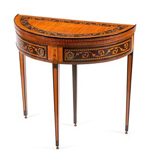 An Italian Neoclassical Inlaid Demilune Games Table
Height 31 x length 32 x depth 16 inches.