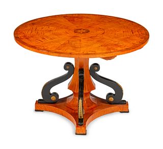 An Austrian Part Ebonized and Inlaid Ash and Walnut Center Table
Height 29 x diameter 43 1/2 inches.