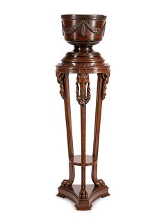A George III Style Carved Mahogany Jardiniere on Pedestal
Height 57 1/2 x diameter 17 inches.