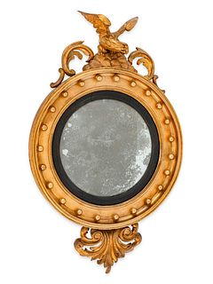 A Regency Style Giltwood Convex Mirror
Height 38 x width 23 1/2 x depth 5 1/2 inches.