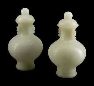 A Pair of Chinese White Peking Glass Covered Vases
Height 15 x diameter 8 1/2 inches.