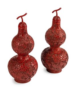 A Pair of Chinese Red Lacquer Double Gourd-Form Vases and Covers
Height 25 x diameter 10 inches.
