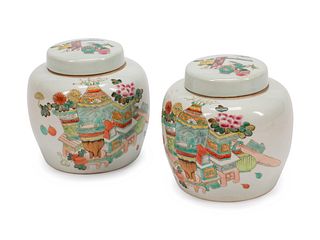 A Pair of Chinese Polychromed Porcelain Covered Jars
Height 6 1/2 x diameter 6 inches.