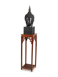 A Large Thai Bronze Head of Buddha
Height overall 90 x width 17 x depth 17 inches.