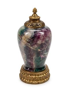 A Chinese Gilt-Bronze-Mounted Carved Flourite Urn
Height 16 x diameter 7 inches.