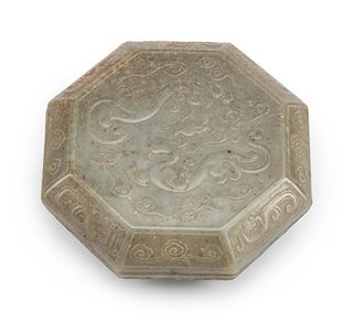 A Chinese Carved Jadeite Octagonal Box and Cover
Height 2 x width 6 inches.