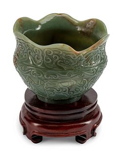 A Chinese Carved Jadeite Bowl
Height 8 1/2 x diameter 7 1/2 inches.