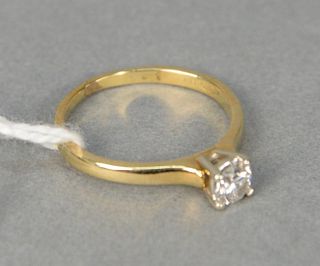 18 karat yellow gold and diamond engagement ring with center diamond approximately .25 carats, size 5.