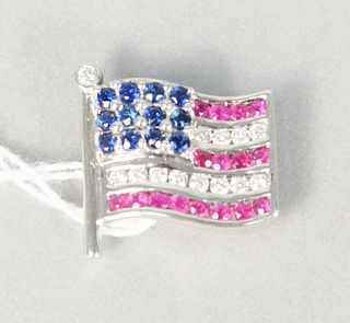 18 karat white gold, diamond, ruby, and sapphire American flag pin, lined with small round rubies and twelve round diamonds, approximately .35 carats,