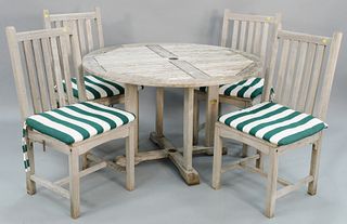 Five piece teak outdoor lot to include a round teak table and four Kingsley Bate chairs with custom cushions, dia. 47".