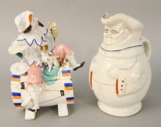 Two figural pieces to include Jester or joker sitting on a drum with a dog box, ht: 9 1/2", along with a McKinley campaign Toby jug, 9". Estate of Mar