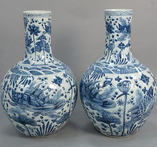 Pair large blue and white vases depicting fish, one cracked near base and top, ht. 32". Provenance: Estate of Mark W. Izard MD, Cider Brook Road, Avon