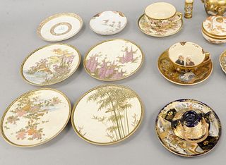 Two tray lots of Satsuma to include small vase or toothpick holder having black and gold mark on bottom; group of four small plates; two covered jars;