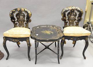 Three black lacquered pieces, pair of chairs gilt decorated with inlaid mother of pearl along with tray top table, ht. 19", top 22" x 26".