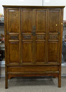 Chinese Elmwood cupboard, 20th C., paneled doors opening to an interior space, ht. 72", width 52", dp. 21".