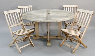 Five piece outdoor teak set, Gloster round dining table, ht. 30", dia. 54"; along with four painted folding chairs, ht. 35".